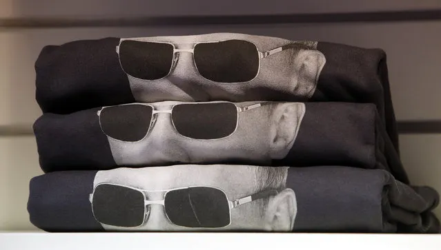 Sweatshirts bearing an image of Russia's President Vladimir Putin wearing sunglasses are displayed on a rack at GUM department store in central Moscow, October 7, 2014. Putin marks his 62nd birthday on Tuesday. (Photo by Sergei Karpukhin/Reuters)