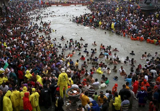 Devotees attend the third “Shahi Snan” (grand bath) on the banks of Godavari river at the ongoing Kumbh Mela or Pitcher Festival in Nashik, India, September 18, 2015. (Photo by Danish Siddiqui/Reuters)