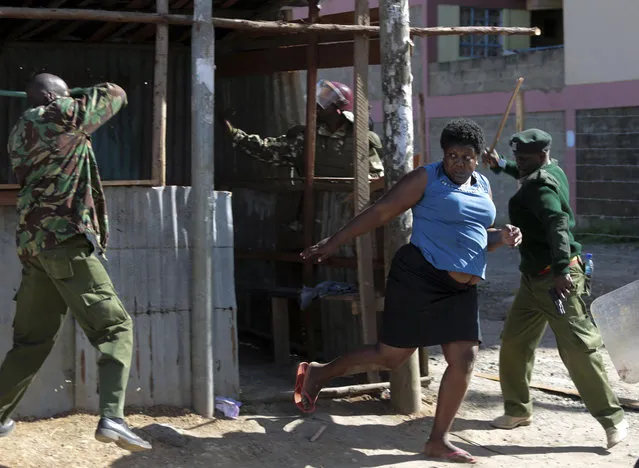 A woman is chased away as police try to stop the opposition from holding demonstrations in Nairobi, Kenya, Tuesday, November 28, 2017. (Photo by Brian Inganga/AP Photo)