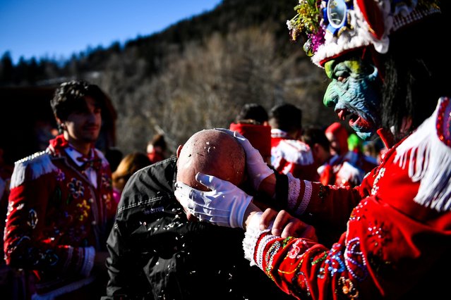 People dressed in colorful clothes and wearing scary wooden masks decorated with mirrors they play pranks on people watching the carnival parade during the Napoleon-themed Coumba Freida Carnival on January 27, 2024 in Doues near Aosta, Italy. The typical costumes of this carnival recall the passage of the soldiers following Napoleon in May 1800. (Photo by Stefano Guidi/Getty Images)