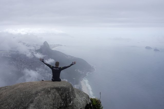 Ezequiel da Luz, a para-athlete with an amputated leg and no movement in his lower limbs, celebrates reaching the top of Pedra da Gavea, with an organization that aims to increase accessibility in trails, in Rio de Janeiro, Wednesday, December 18, 2024. (Photo by Lucas Dumphreys/AP Photo)