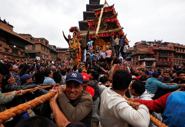 Devotees pull the chariot of God Bhairab through the city center during the Biska festival in Bhaktapur, Nepal on April 10, 2025. (Photo by Navesh Chitrakar/Reuters)