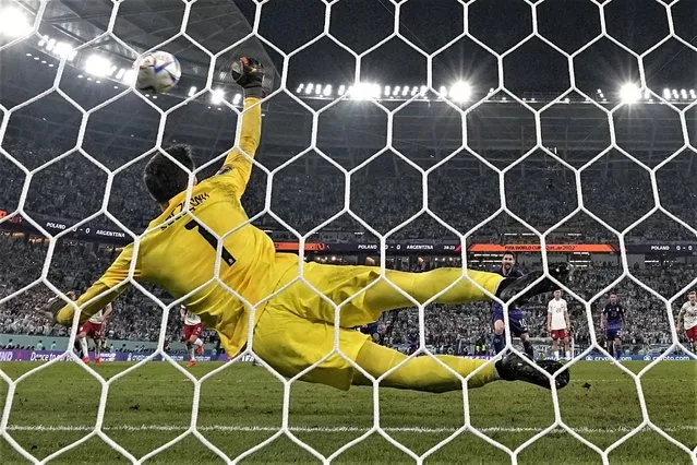 Poland's goalkeeper Wojciech Szczesny saves a penalty kick by Argentina's Lionel Messi during the World Cup group C soccer match between Poland and Argentina at the Stadium 974 in Doha, Qatar, Wednesday, November 30, 2022. (Photo by Ariel Schalit/AP Photo)