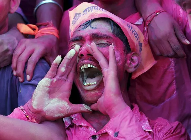 A devotee daubed in colour shouts religious slogans as he takes part in the immersion of an idol of the Hindu god Ganesh, the deity of prosperity, during the ten-day-long Ganesh Chaturthi festival in Ahmedabad, India, September 23, 2015. (Photo by Amit Dave/Reuters)