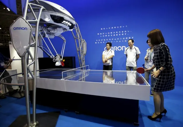 A woman plays table tennis with Japan's Omron Corp's table tennis playing robot at CEATEC (Combined Exhibition of Advanced Technologies) JAPAN 2015 in Makuhari, Japan, October 6, 2015. (Photo by Yuya Shino/Reuters)