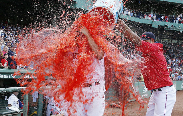 Teammates douse Boston Red Sox's Xander Bogaerts after the Red Sox defeated the New York Yankees 6-5 in a baseball game in Boston, Saturday, September 17, 2016. (Photo by Michael Dwyer/AP Photo)