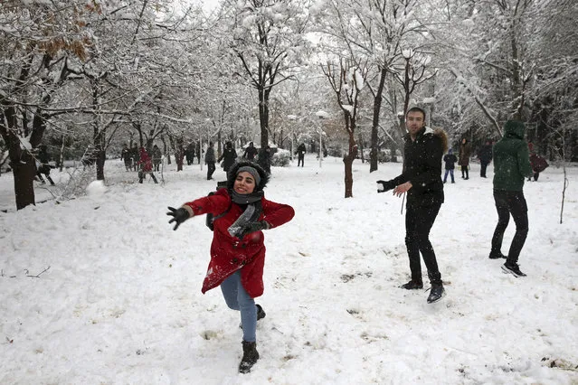 Iranian university students throw snowballs in Laleh Park in central Tehran, Iran, Sunday, January 28, 2018. While Iran's first heavy snowfall of the season has forced both international airports and schools in the capital to close, many people went to streets and parks to play and enjoy the rare snowy day. (Photo by Vahid Salemi/AP Photo)