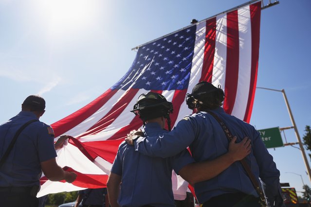 The Coeur d'Alene Fire Dept. hangs an American flag to honor the firefighters who were killed Sunday, in Coeur d'Alene, Idaho, on Tuesday, July 1, 2025. (Photo by Lindsey Wasson/AP Photo)