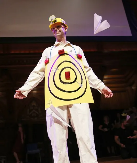 Human Aeorodrome Eric Workman acts as a target for paper airplanes during the Ig Nobel award ceremonies at Harvard University in Cambridge, Mass., Thursday, September 22, 2016. (Photo by Michael Dwyer/AP Photo)