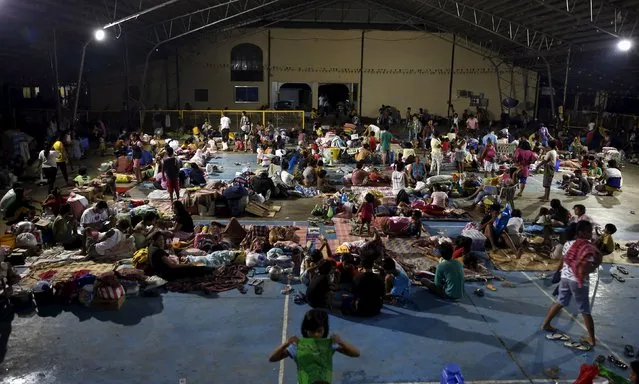 Typhoon victims take shelter at a gymnasium of a public school turned into an evacuation centre in Cabanatuan city, Nueva Ecija in northern Philippines October 19, 2015, after it was hit by Typhoon Koppu. (Photo by Erik De Castro/Reuters)