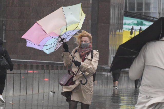 A woman struggles with an umbrella in strong winds and rain, in London, Britain, October 2, 2020 as storm Alex brings strong 70mph gale force winds to many parts of the UK. (Photo by Evening Standard/The Sun)
