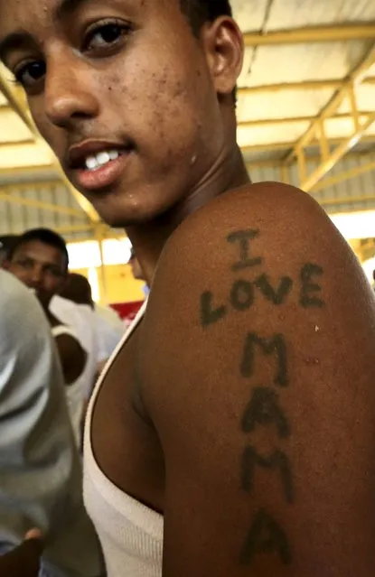 An Eritrean asylum seeker reacts to the camera inside a new arrivals center in Wad Sharifey refugee camp during a visit by European Union Ambassadors to the camp at Kassala State in East Sudan October 22, 2015. (Photo by Mohamed Nureldin Abdallah/Reuters)