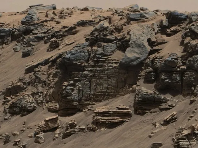 An evenly-layered rock on the planet Mars, photographed by the Mast Camera (Mastcam) on NASA's Curiosity Mars Rover is shown in the NASA handout provided December 9, 2014. It shows a pattern typical of a lake-floor sedimentary deposit not far from where flowing water may have entered a lake in a scene combining multiple frames taken with Mastcam's right-eye camera on August 7, 2014. (Photo by Reuters//NASA/JPL-Caltech/MSSS)