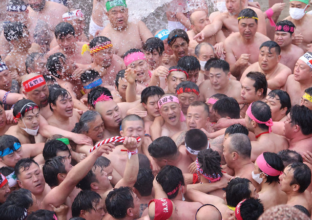 The battalions of men in fundoshi, light cotton loincloth, compete to touch the “Lucky Man” during the Hadaka Matsuri, Naked Festival at Konomiya Shrine in Inazawa city, Aichi Prefecture on February 3rd, 2023. The 1,200-year history ritual took place in three years due to the COVID pandemic. (Photo by Hisao Aoki/The Yomiuri Shimbun via AFP Photo)