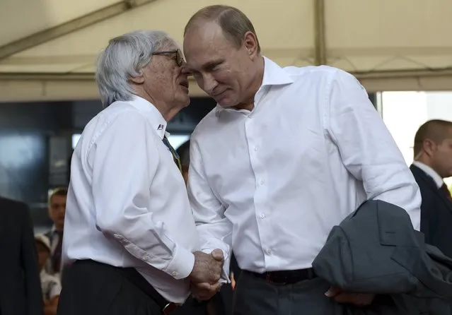 Russia's President Vladimir Putin (R) shakes hands with Formula One commercial supremo Bernie Ecclestone during the first Russian Grand Prix in Sochi, in this October 12, 2014 file photo. (Photo by Alexei Nikolskyi/Reuters)