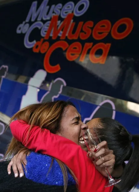 Madrid Wax Museum's worker Noemi Vazquez (L) and her sister Maria celebrate having won a portion of the Spain's Christmas Lottery “El Gordo” in Madrid December 22, 2014. (Photo by Juan Medina/Reuters)