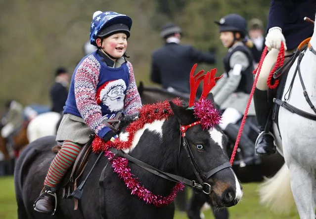 A horse wears toy reindeer antlers during the traditional Quorn Hunt Boxing Day meet at Prestwold Hall near Loughborough December 26, 2014. (Photo by Darren Staples/Reuters)