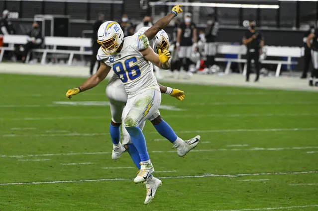 Los Angeles Chargers tight end Hunter Henry (86) and running back Joshua Kelley (27) celebrate after a teammate recovered a Los Angeles Chargers fumble in overtime of an NFL football game against the Las Vegas Raiders, Thursday, December 17, 2020, in Las Vegas. (Photo by David Becker/AP Photo)