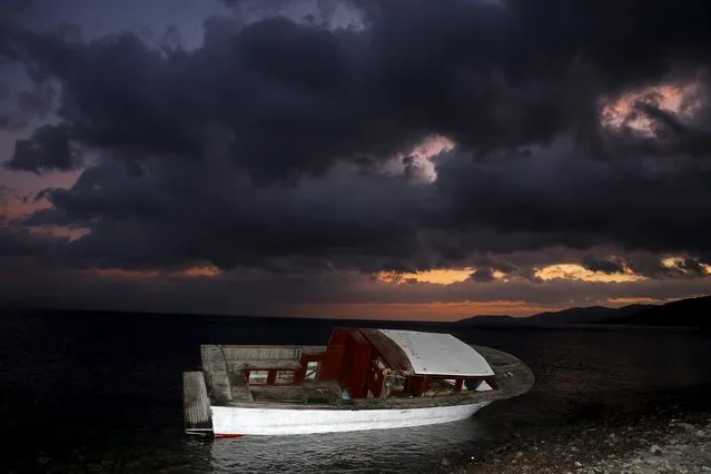 A boat used by refugees and migrants to travel across the Aegean Sea from the Turkish coast in the Greek island of Lesbos is seen at a beach November 21, 2015. Balkan countries have begun filtering the flow of migrants to Europe, granting passage to those fleeing conflict in the Middle East and Afghanistan but turning back others from Africa and Asia, the United Nations and Reuters witnesses said on Thursday. (Photo by Yannis Behrakis/Reuters)