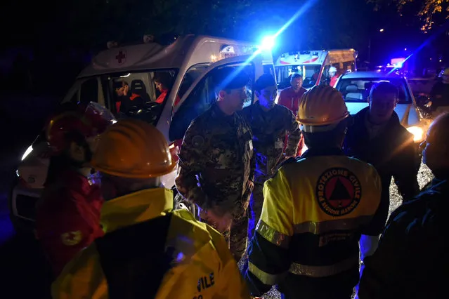 Rescuers gather in the village of Visso, central Italy, Wednesday, October 26, 2016 following an earthquake. A pair of powerful aftershocks shook central Italy on Wednesday, knocking out power, closing a major highway and sending panicked residents into the rain-drenched streets just two months after a powerful earthquake killed nearly 300 people. (Photo by Matteo Crocchioni/ANSA via AP Photo)