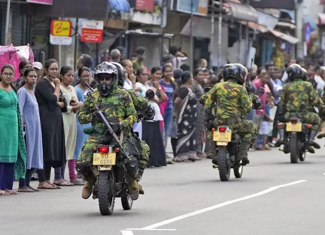 Sri Lankan policemen patrol on the motorcycles during a silent protest march by the Catholics to mark the fourth year commemoration of the 2019, Easter Sunday bomb attacks on their Churches, in Colombo, Sri Lanka, Friday, April 21, 2023. Thousands of Sri Lankans held a protest in the capital on Friday, demanding justice for the victims of the 2019 Easter Sunday bomb attacks that killed nearly 270 people. (Photo by Eranga Jayawardena/AP Photo)