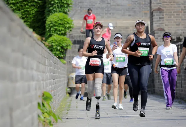 Portuguese Adriele Silva (L) runs during the Great Wall Marathon at the Huangyaguan section of the Great Wall of China, in Jixian of Tianjin, China May 19, 2018. (Photo by Jason Lee/Reuters)