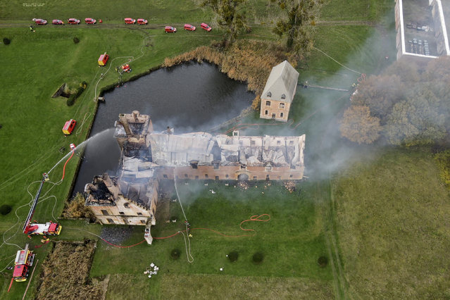 This aerial photograph taken and released on November 2, 2025 by the Sdis 08 shows firefighters working on the fire of the former monastery of the Charterhouse of Mont-Dieu, a site listed as a historical monument, in Tannay-le-Mont-Dieu, north-eastern France on November 2, 2025. The main building of the former monastery has been destroyed according to the mayor of the municipality Anne Fraipont and firefighters interviewed by AFP. (Photo by Handout/SDIS08/AFP Photo)