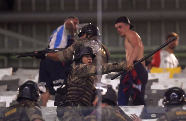 Military Police confront San Lorenzo fans during the Copa Libertadores round of 16 second leg football match between Brazil's Atletico Mineiro and Argentina's San Lorenzo at the Arena MRV stadium in Belo Horizonte, Brazil, on August 20, 2024. (Photo by Douglas Magno/AFP Photo)