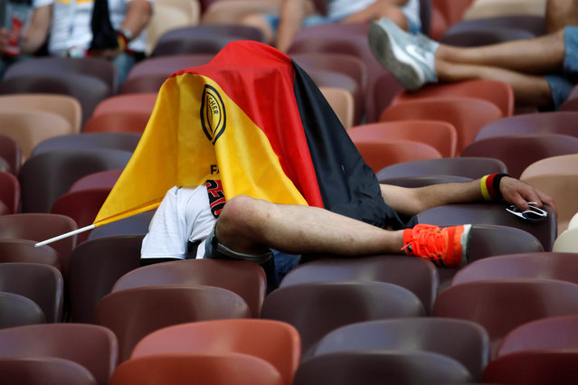 Germany fan covers their face with a flag in after the match between Germany and Mexico in Saint Petersburg on June 17, 2018 during the Russia 2018 football World Cup tournament. (Photo by Carl Recine/Reuters)