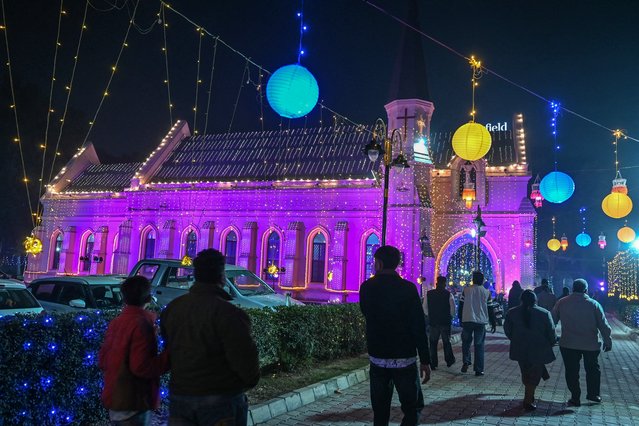 People visit the illuminated St. Paul's Church ahead of the Christmas celebrations in Amritsar on December 22, 2024. (Photo by Narinder Nanu/AFP Photo)