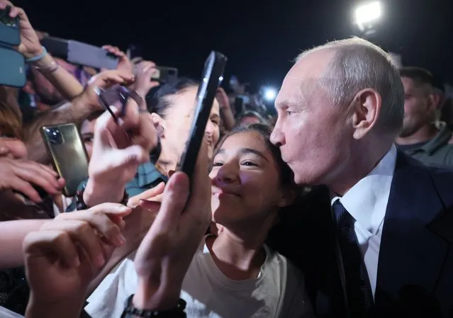 Russian President Vladimir Putin (R) meets with people in a street during a working trip to Dagestan, in Derbent, Russia's Republic of Dagestan, 28 June 2023 (issued 29 June 2023). The growth of domestic tourism in Russia is provided, among other things, by sanctions from a number of states, said Russian President Vladimir Putin. Putin, in particular, drew attention to the tourism potential of the North Caucasus. (Photo by Gavriil Grigorov/EPA)