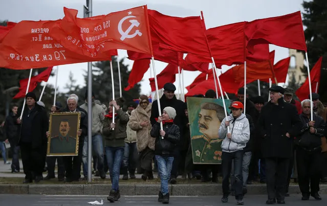 People carry flags and portraits of Soviet leader Joseph Stalin while marching during a rally to mark Stalin's birthday anniversary at his hometown in Gori, Georgia, December 21, 2015. (Photo by David Mdzinarishvili/Reuters)