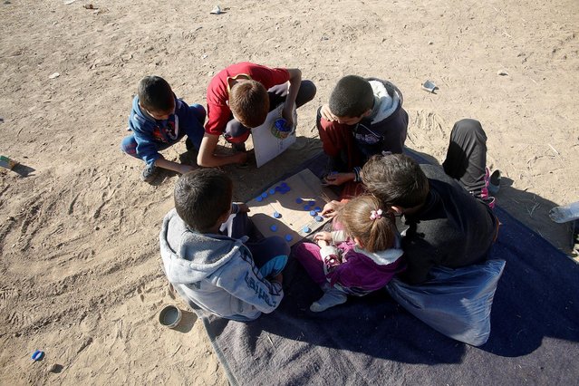 Displaced children from the outskirts of Mosul play in the town of Bashiqa, after it was recaptured from the Islamic State, east of Mosul, Iraq, November 18, 2016. (Photo by Khalid al Mousily/Reuters)