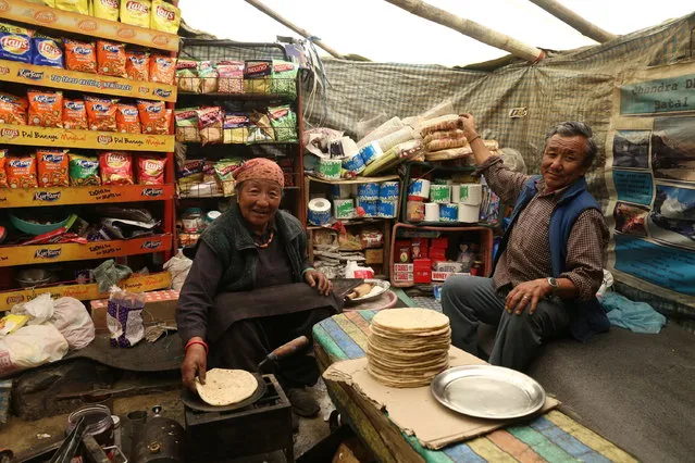 Bodh Dorjee (R) and his wife Hishe Chhomo prepare food in their famous Chandra Dhaba, also known as Chacha Chachi Dhaba, in Batal, in the remote area of Lahaul and Spiti Valley in Himachal Pradesh State, northern India, 28 July 2018. The famous eatery joint is the only one catering to tourists in the remote area. It is open for four months only as the roads become inaccessible during Winter due to the snow. The couple who runs the Dhaba, are lovingly called by the visitors as Chacha and Chachi, which means paternal uncle and paternal aunt, and thus the name Chacha Chachi Dhaba was coined. (Photo by Sanjay Baid/EPA/EFE)