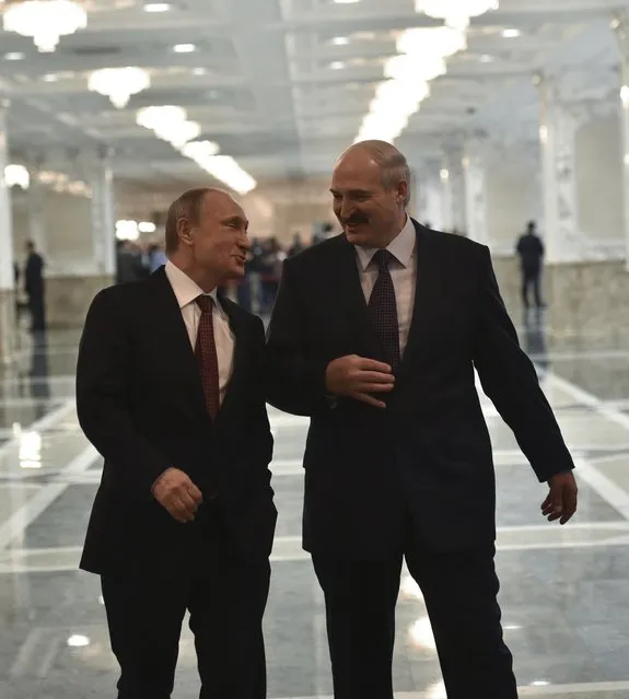 Russia's President Vladimir Putin (L) talks to Belarus' President Alexander Lukashenko before a meeting on resolving the Ukrainian crisis in Minsk, February 11, 2015. (Photo by Mykola Lazarenko/Reuters)