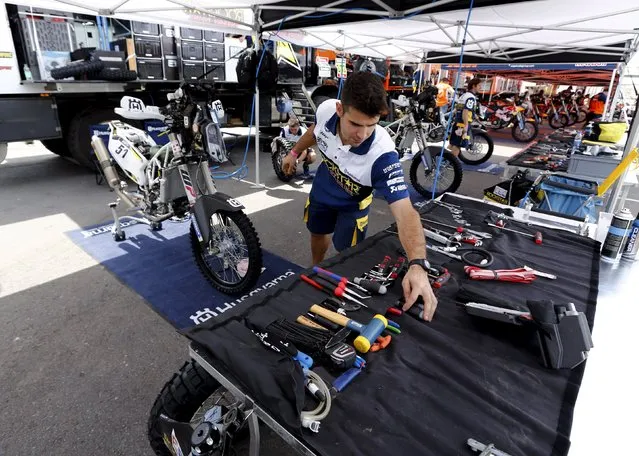 A mechanic of the Husqvarna Racing Team works in the team's box ahead of the Dakar Rally 2016 in Buenos Aires, Argentina, December 31, 2015. (Photo by Marcos Brindicci/Reuters)