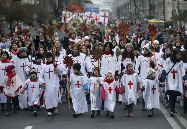 Participants march on the street during "Alilo", a religious procession to celebrate Orthodox Christmas in Tbilisi, Georgia, January 7, 2016. Georgian Orthodox believers celebrate Christmas on January 7, according to the Julian calendar. (Photo by David Mdzinarishvili/Reuters)