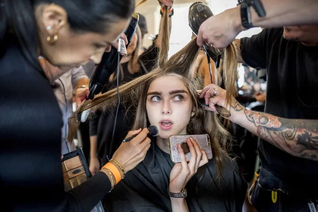 A model has her hair and make-up done backstage ahead of a show of British designer Jasper Conran at the London Fashion Week, in London, Britain, 15 September 2018. (Photo by Tolga Akmen/EPA/EFE)