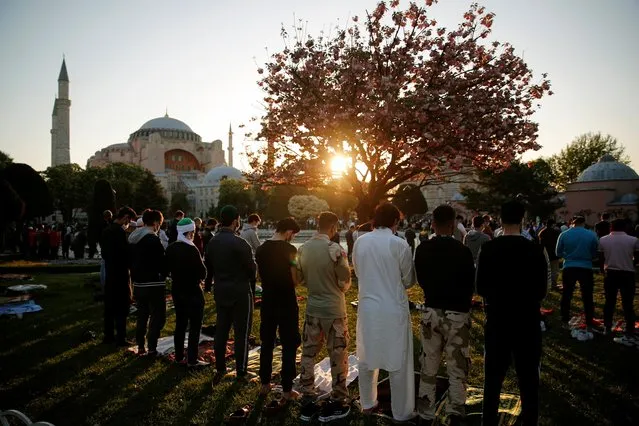 People attend Eid al-Fitr prayers marking the end of the fasting month of Ramadan, outside the Hagia Sophia Grand Mosque in Istanbul, Turkey on May 13, 2021. (Photo by Kemal Aslan/Reuters)