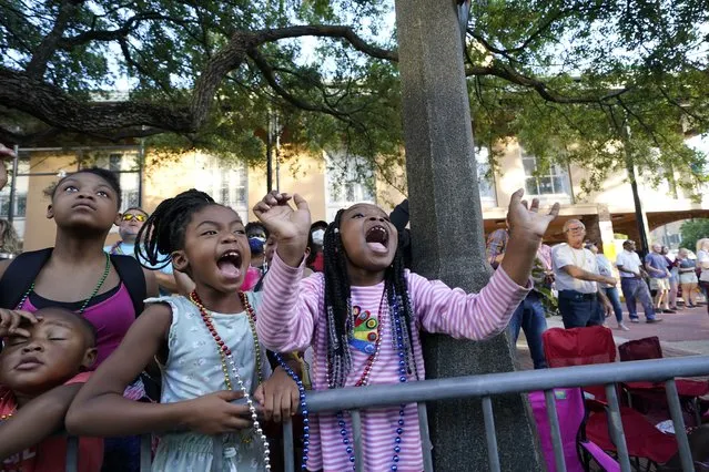 Children scream for throws during a parade dubbed “Tardy Gras”, to compensate for a cancelled Mardi Gras due to the COVID-19 pandemic, in Mobile, Ala., Friday, May 21, 2021. (Photo by Gerald Herbert/AP Photo)