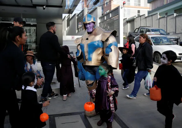 People in costume attend Halloween celebrations in La Paz, Bolivia on October 31, 2018. (Photo by David Mercado/Reuters)