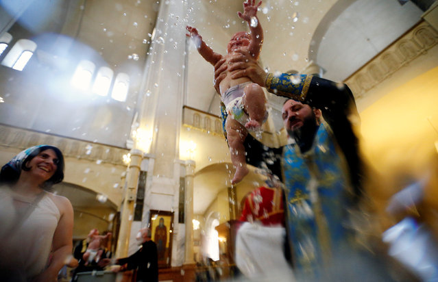 GEORGIA: A baby is baptized during a mass baptism ceremony at the Holy Trinity Cathedral in Tbilisi, Georgia July 13, 2016. (Photo by David Mdzinarishvili/Reuters)