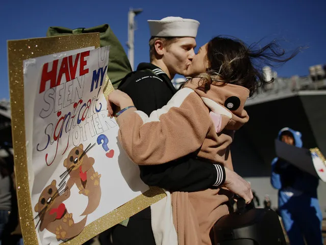 In costume and carrying a sign reading, “Have u seen my significant otter?” Melanie Till welcomes her husband, P.O. 3rd Class David Till, home after the USS Dwight D. Eisenhower returned to Naval Station Norfolk, in Norfolk, Va., on Friday, December 30, 2016, from a seven-month deployment to the Middle East and the Mediterranean Sea. (Photo by Stephen M. Katz/The Virginian-Pilot via AP Photo)