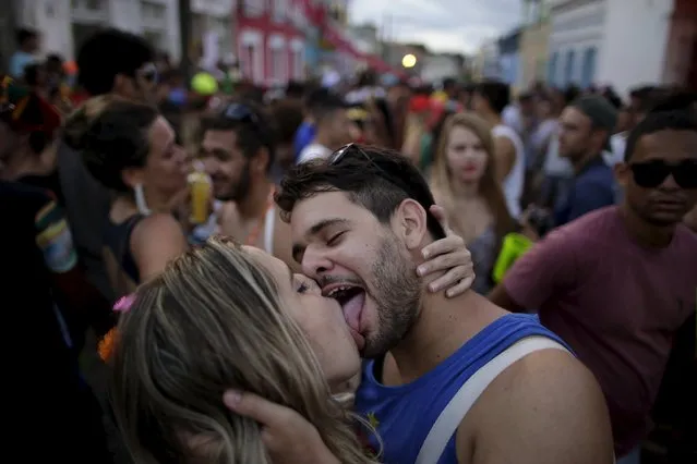 Revellers kiss during a carnival party in a neighborhood in Olinda, Brazil February 7, 2016. (Photo by Ueslei Marcelino/Reuters)