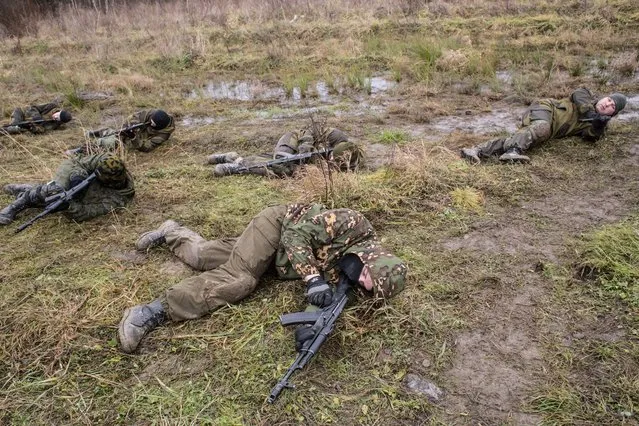 Participants of PARTISAN courses train covering behind low objects during tactical field trainings in Olgino, St. Petersburg, Russia on November 22, 2016. (Photo by Alexander Aksakov/The Washington Post)