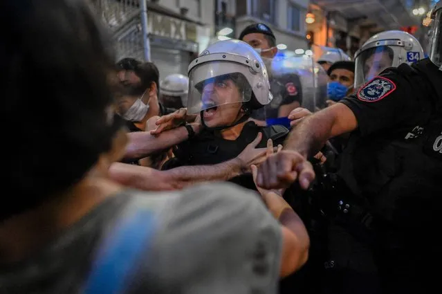 Turkish police clash with demonstrators during a protest against Turkey's decision to withdraw from the Istanbul Convention, in Istanbul, on July 1, 2021. Police fired tear gas at protesters in Istanbul demonstrating against Turkey's controversial exit on July 1, 2021 from a treaty combatting femicide and domestic abuse. Turkish President Recep Tayyip Erdogan sparked international outrage in March by pulling out of the world's first binding treaty to prevent and combat violence against women, known as the Istanbul Convention. (Photo by Bulent Kilic/AFP Photo)