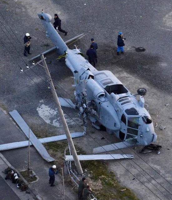 The remains of a crashed U.S. military helicopter is seen in Miura, south of Tokyo, in this photo taken by Kyodo December 16, 2013. A U.S. military helicopter crash-landed in a coastal city south of Tokyo on Monday, injuring two of its four-man crew, Kyodo news reported. Mandatory credit. (Photo by Reuters/Kyodo)