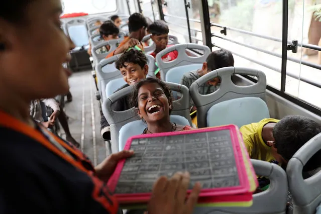 Gauri, 8, reacts inside a parked bus run by TejasAsia, an NGO using “Hope” buses as mobile classrooms for children living in slums, near the Tughlaqabad fort in New Delhi, India on August 9, 2021. (Photo by Anushree Fadnavis/Reuters)