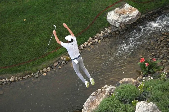 Joaquin Niemann, of Chile, leaps over a creek after looking for his ball in the rough near the 18th green during the second round of the BMW Championship golf tournament, Friday, August 27, 2021, at Caves Valley Golf Club in Owings Mills, Md. (Photo by Nick Wass/AP Photo)
