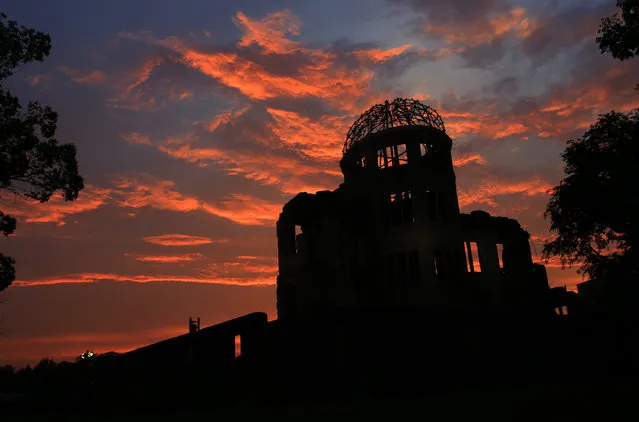 In this August 5, 2013 file photo, the Atomic Bomb Dome is silhouetted at sunset in Hiroshima, western Japan, a day before Hiroshima marks the 68th anniversary of the world's first atomic bombing. Seventy years after the U.S. defeated Japan in World War II, Americans are divided over Japan playing a more active military role in Asia – and most Japanese are opposed. (Photo by Shizuo Kambayashi/AP Photo)